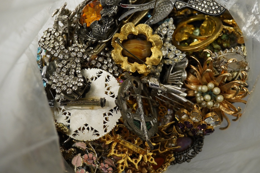 Four large bags of assorted costume jewellery including, brooches, necklaces, bangles, etc. Condition - poor to fair to good